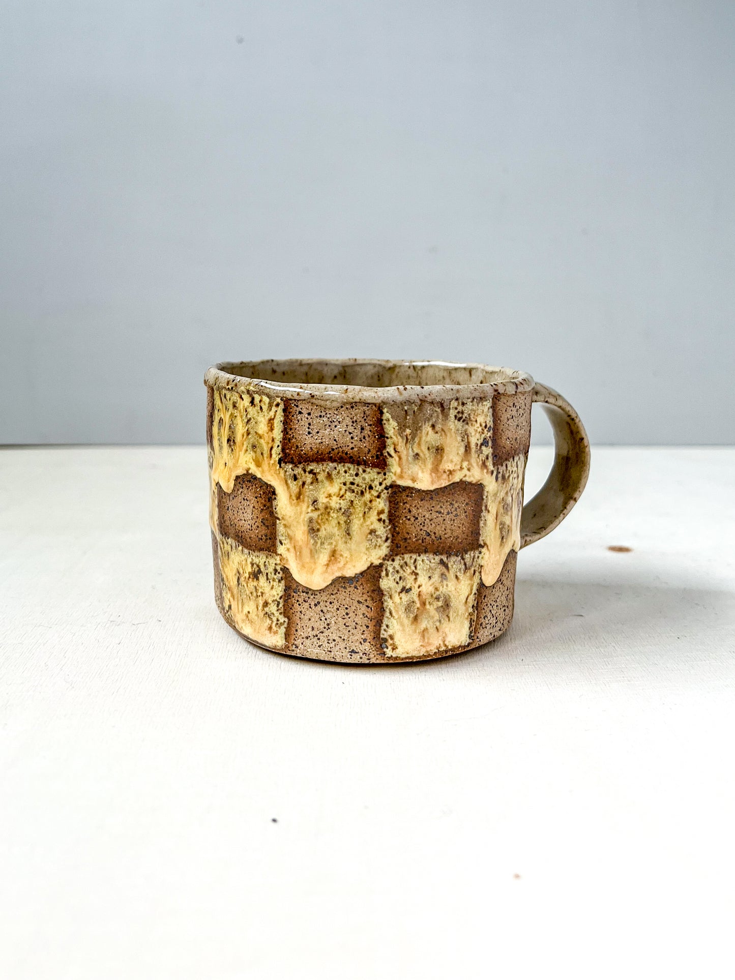 yellow speckled grid mug